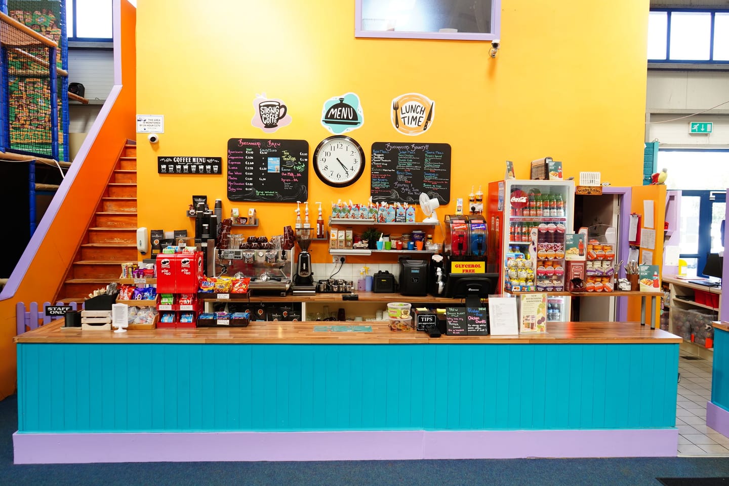 Wide view of the café counter facing the family seating.