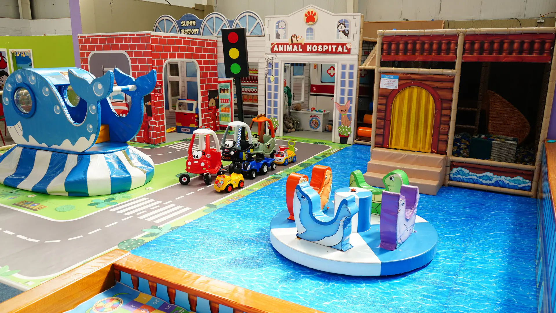 Wide view of the separate Toddler Area with low play features and role-play façades.